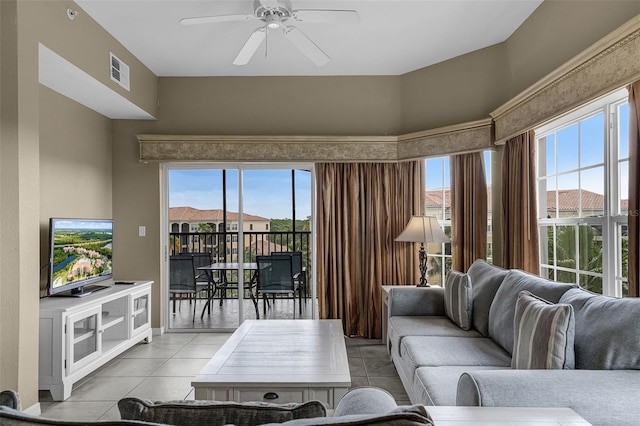 living room featuring light tile patterned floors, ceiling fan, and visible vents