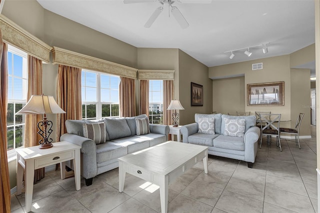 living area featuring ceiling fan, light tile patterned flooring, and visible vents