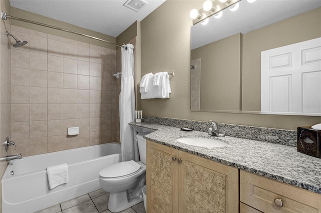 bathroom featuring toilet, vanity, shower / tub combo with curtain, visible vents, and tile patterned flooring