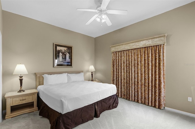 carpeted bedroom featuring a ceiling fan and baseboards