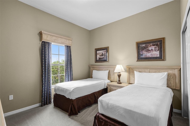 carpeted bedroom with baseboards