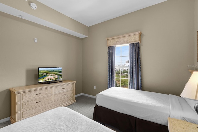 bedroom featuring carpet and baseboards