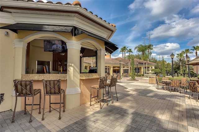 view of patio featuring exterior bar