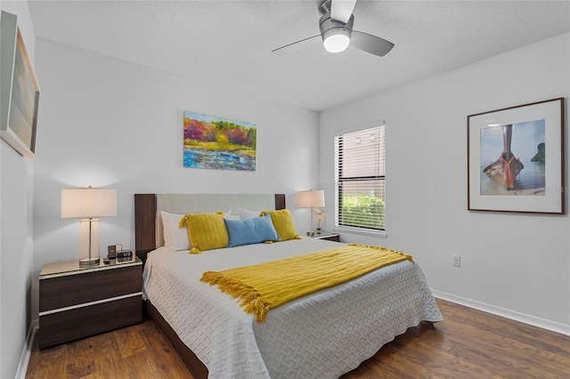 bedroom featuring wood finished floors, baseboards, and a ceiling fan