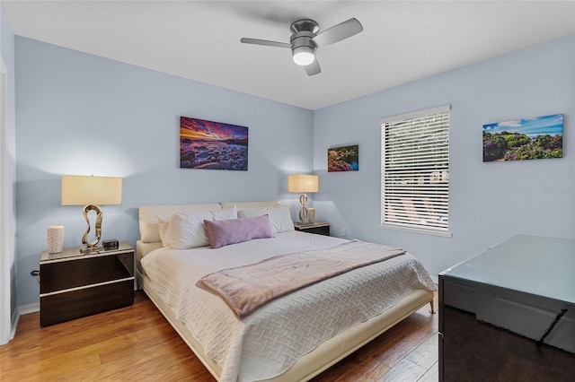 bedroom featuring wood finished floors, ceiling fan, and baseboards