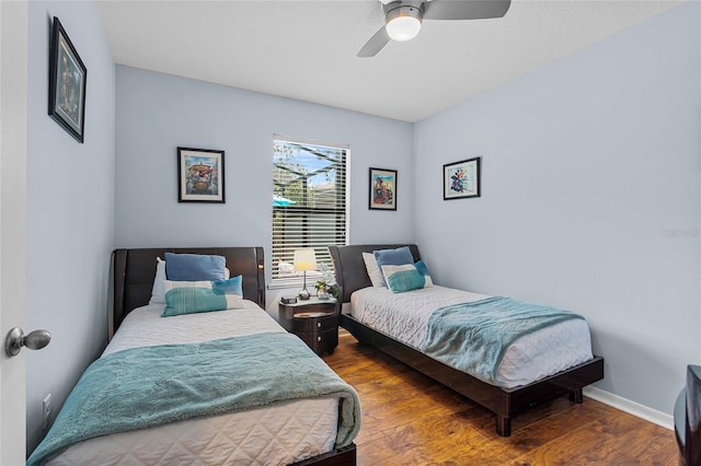 bedroom with wood finished floors, ceiling fan, and baseboards