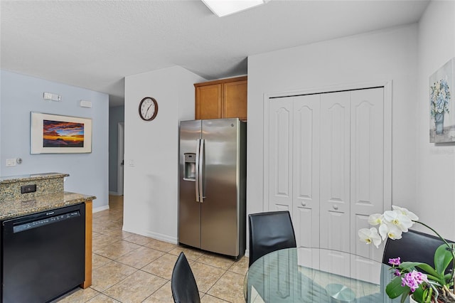 kitchen with stainless steel fridge with ice dispenser, dishwasher, brown cabinets, light tile patterned floors, and stone countertops