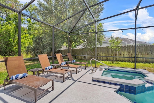 view of swimming pool with a patio, an in-ground hot tub, fence, and glass enclosure