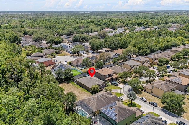 aerial perspective of suburban area featuring a heavily wooded area