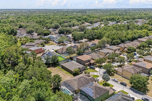 aerial perspective of suburban area featuring a heavily wooded area