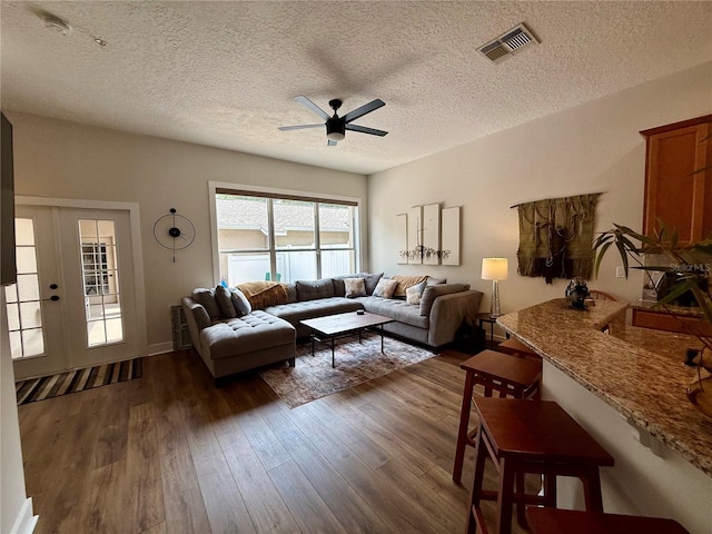 2287 Park Maitland Ct, Maitland, FL 32751 - living area with ceiling fan, a textured ceiling, dark wood-style flooring, and visible vents