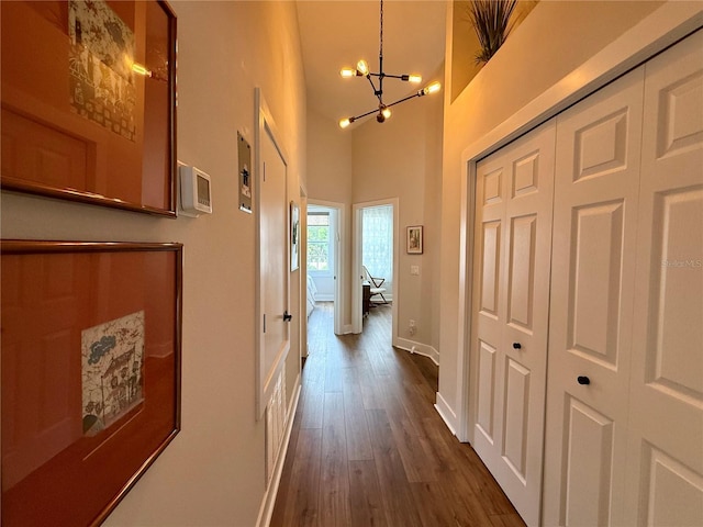 2287 Park Maitland Ct, Maitland, FL 32751 - corridor with an inviting chandelier, baseboards, a high ceiling, and dark wood-style floors