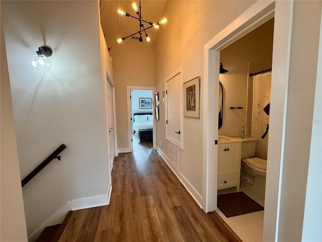 2287 Park Maitland Ct, Maitland, FL 32751 - corridor with baseboards, a notable chandelier, a towering ceiling, and wood finished floors
