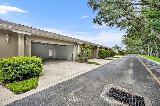 2287 Park Maitland Ct, Maitland, FL 32751 - view of home's exterior featuring an attached garage, stucco siding, and driveway
