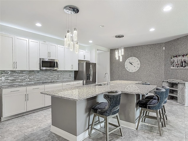 12313 Prairie Plantation Way, Orlando, FL 32824 - kitchen with stainless steel appliances, a sink, backsplash, light stone counters, and recessed lighting