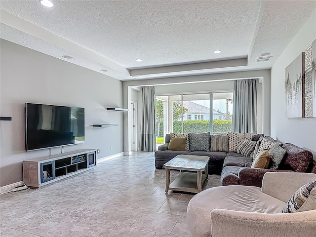 12313 Prairie Plantation Way, Orlando, FL 32824 - living area with a textured ceiling, baseboards, a tray ceiling, and recessed lighting