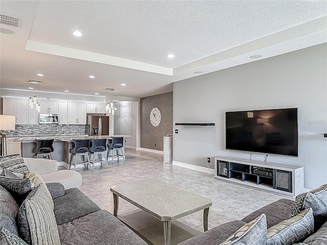 12313 Prairie Plantation Way, Orlando, FL 32824 - living area with baseboards, a textured ceiling, and recessed lighting