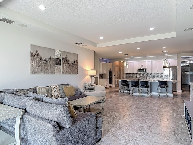 12313 Prairie Plantation Way, Orlando, FL 32824 - living area featuring recessed lighting and a textured ceiling
