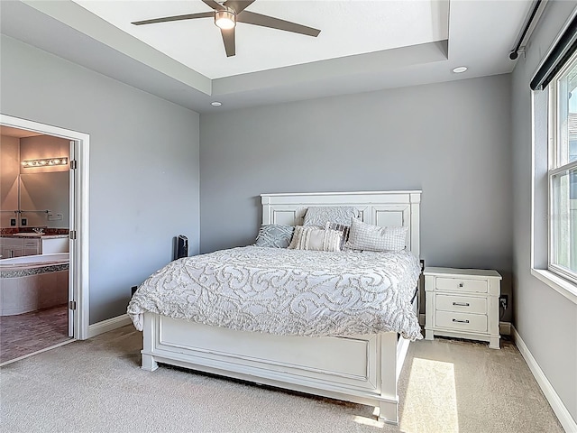 12313 Prairie Plantation Way, Orlando, FL 32824 - bedroom featuring light colored carpet, baseboards, ceiling fan, and ensuite bath