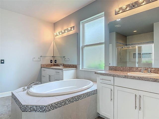 12313 Prairie Plantation Way, Orlando, FL 32824 - bathroom with a shower stall, a garden tub, and two vanities