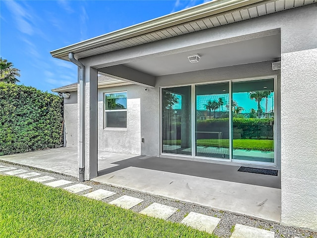 12313 Prairie Plantation Way, Orlando, FL 32824 - view of exterior entry featuring stucco siding and a patio