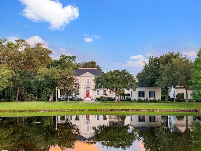 202 Acadia Ter, Kissimmee, FL 34747 - rear view of property with a water view and a lawn