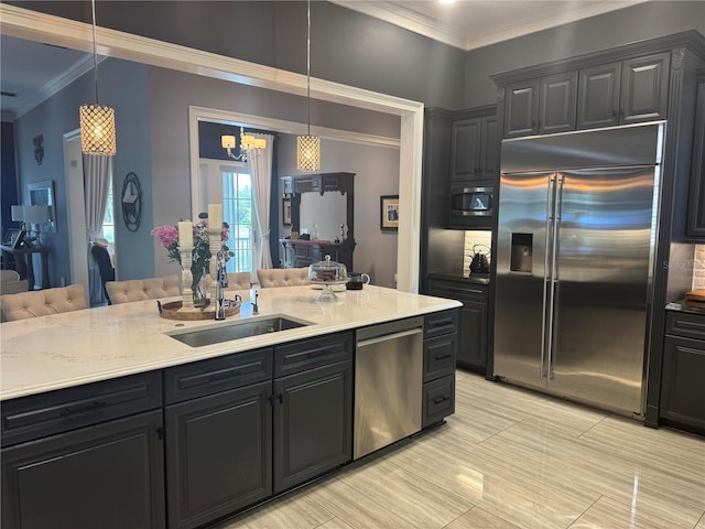 202 Acadia Ter, Kissimmee, FL 34747 - kitchen featuring built in appliances, a sink, crown molding, dark cabinets, and hanging light fixtures