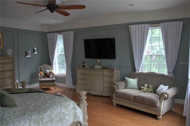 202 Acadia Ter, Kissimmee, FL 34747 - bedroom with light wood-style flooring, ceiling fan, and crown molding