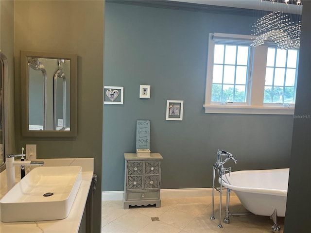 202 Acadia Ter, Kissimmee, FL 34747 - bathroom with baseboards, a freestanding tub, tile patterned flooring, a chandelier, and vanity