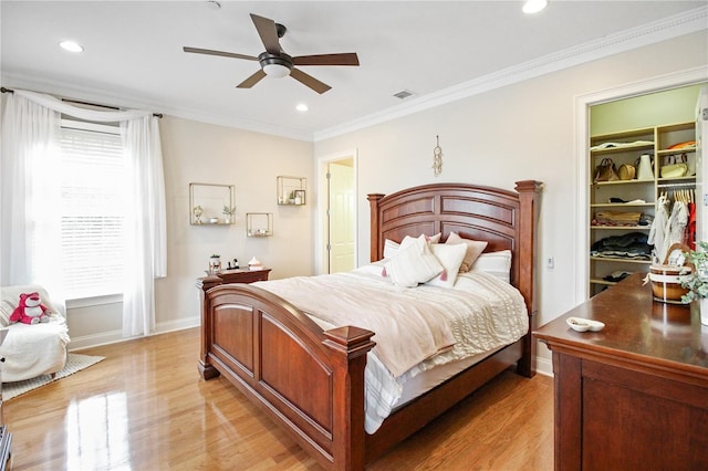 202 Acadia Ter, Kissimmee, FL 34747 - bedroom featuring light wood-style floors, ornamental molding, recessed lighting, a spacious closet, and baseboards