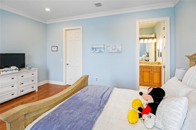 202 Acadia Ter, Kissimmee, FL 34747 - bedroom with wood finished floors, ornamental molding, baseboards, recessed lighting, and connected bathroom