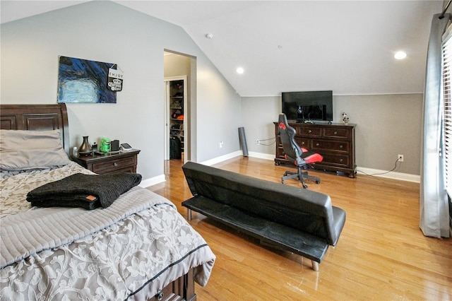 202 Acadia Ter, Kissimmee, FL 34747 - bedroom featuring vaulted ceiling, baseboards, a walk in closet, light wood-style flooring, and recessed lighting
