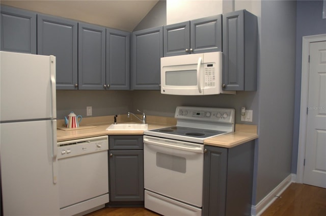 202 Acadia Ter, Kissimmee, FL 34747 - kitchen with white appliances, a sink, gray cabinetry, light countertops, and dark wood-style floors
