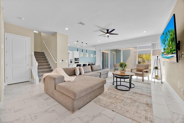 1428 Reunion Blvd, Kissimmee, FL 34747 - living area with light marble finish flooring, a ceiling fan, stairway, baseboards, and recessed lighting