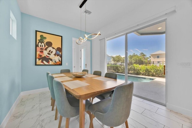 1428 Reunion Blvd, Kissimmee, FL 34747 - dining area featuring light marble finish floors and baseboards