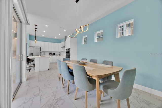 1428 Reunion Blvd, Kissimmee, FL 34747 - dining room with light marble finish flooring, recessed lighting, and baseboards