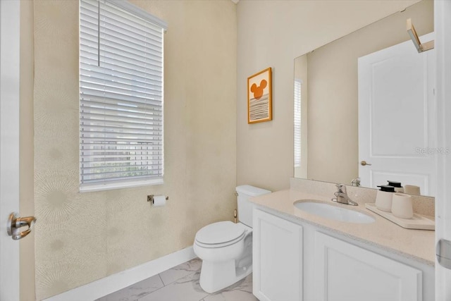 1428 Reunion Blvd, Kissimmee, FL 34747 - half bathroom with marble finish floors, toilet, baseboards, and vanity