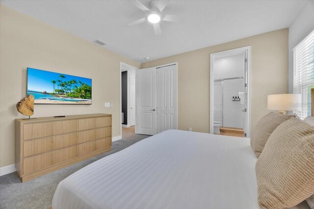1428 Reunion Blvd, Kissimmee, FL 34747 - bedroom featuring baseboards, carpet, ensuite bath, and ceiling fan
