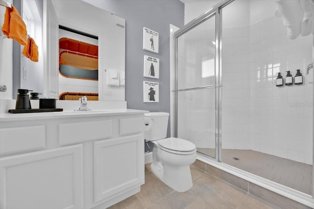1428 Reunion Blvd, Kissimmee, FL 34747 - full bathroom with a stall shower, toilet, tile patterned flooring, and vanity
