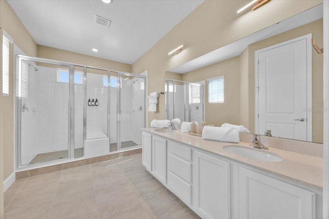 1428 Reunion Blvd, Kissimmee, FL 34747 - full bathroom with a stall shower, double vanity, tile patterned flooring, recessed lighting, and baseboards