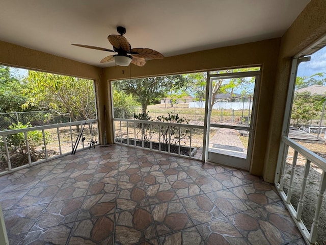 829 Anza Ave, Lehigh Acres, FL 33971 - unfurnished sunroom featuring a ceiling fan