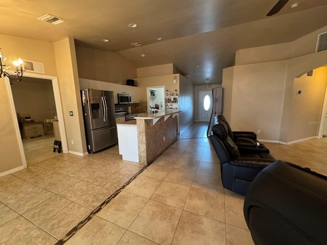 829 Anza Ave, Lehigh Acres, FL 33971 - kitchen featuring open floor plan, white cabinetry, arched walkways, appliances with stainless steel finishes, and light tile patterned flooring