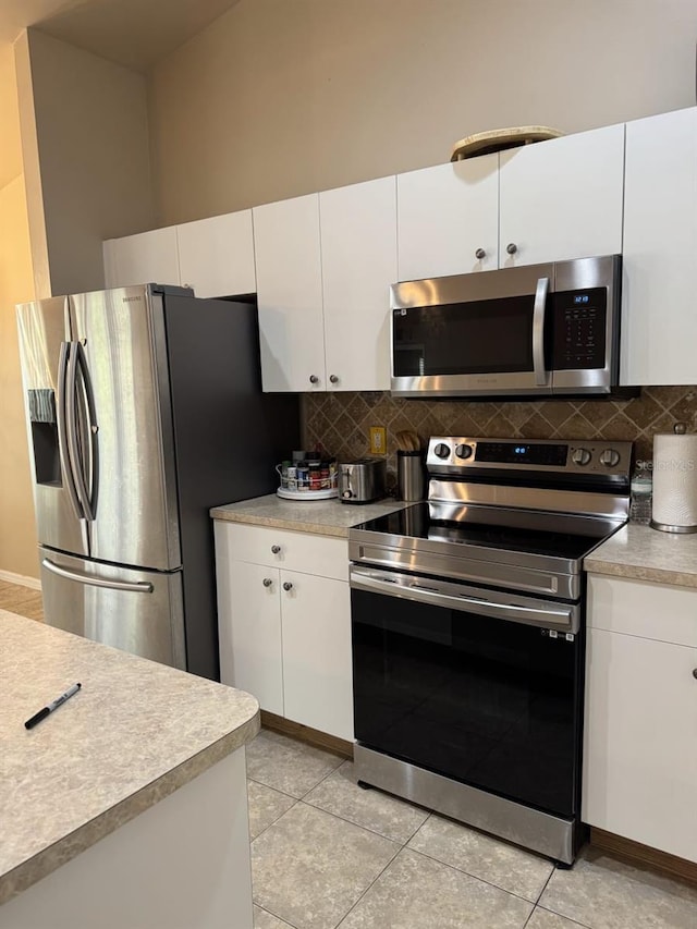 829 Anza Ave, Lehigh Acres, FL 33971 - kitchen featuring tasteful backsplash, light countertops, and appliances with stainless steel finishes
