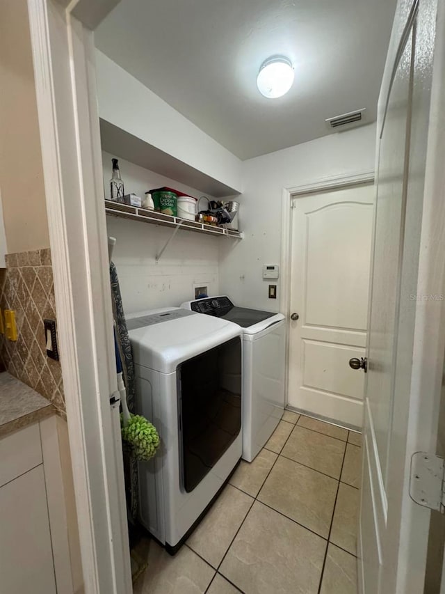 829 Anza Ave, Lehigh Acres, FL 33971 - laundry area with independent washer and dryer, light tile patterned floors, visible vents, and laundry area