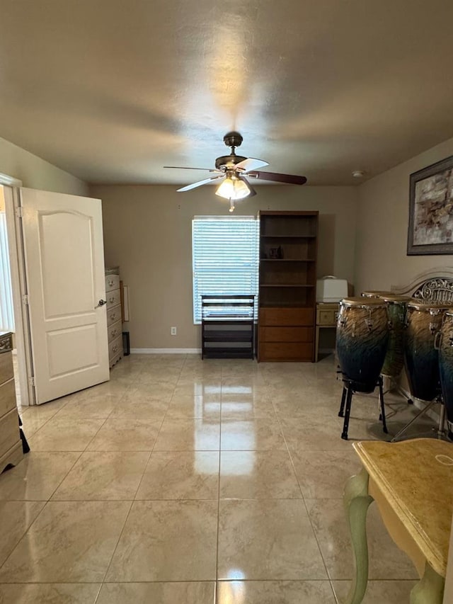 829 Anza Ave, Lehigh Acres, FL 33971 - interior space with light tile patterned flooring, baseboards, and a ceiling fan
