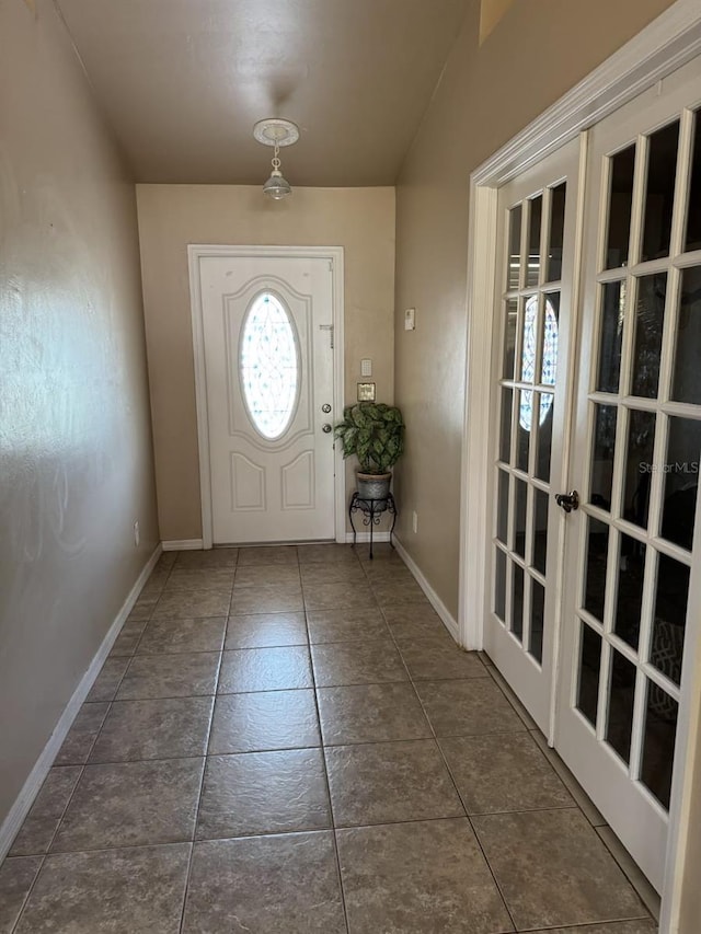 829 Anza Ave, Lehigh Acres, FL 33971 - doorway featuring baseboards, tile patterned floors, and french doors