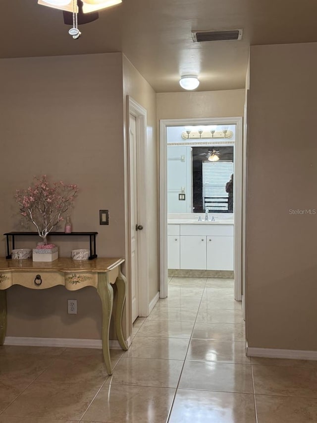829 Anza Ave, Lehigh Acres, FL 33971 - corridor featuring baseboards, light tile patterned floors, visible vents, and a sink