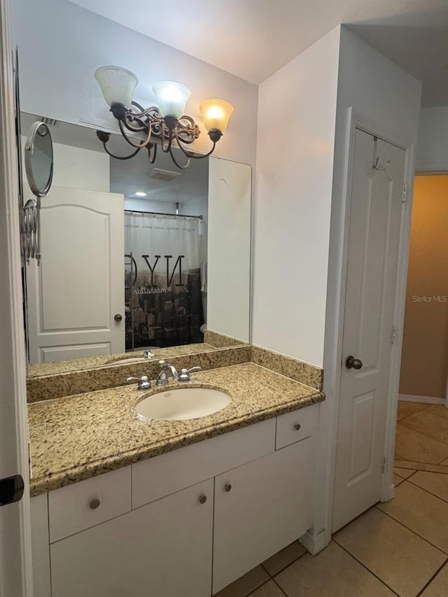 829 Anza Ave, Lehigh Acres, FL 33971 - full bathroom with tile patterned floors, a chandelier, baseboards, and vanity