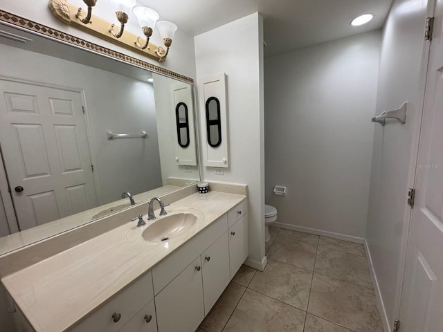 829 Anza Ave, Lehigh Acres, FL 33971 - bathroom with toilet, vanity, visible vents, tile patterned floors, and baseboards