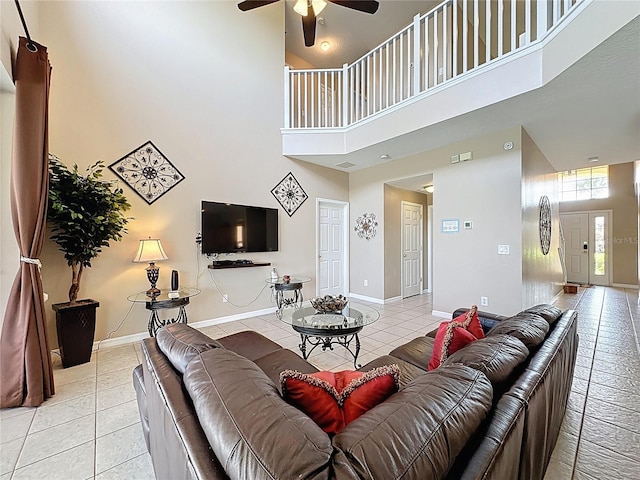 219 Rosso Dr, Davenport, FL 33837 - living area with a towering ceiling, light tile patterned flooring, a ceiling fan, and baseboards